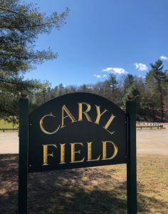 wooden outdoor sign reading caryl field