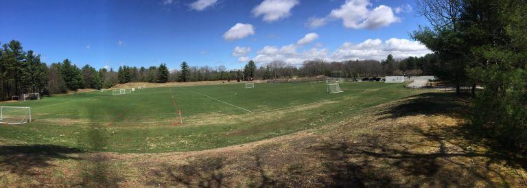 panoramic view of grassy wooded fields