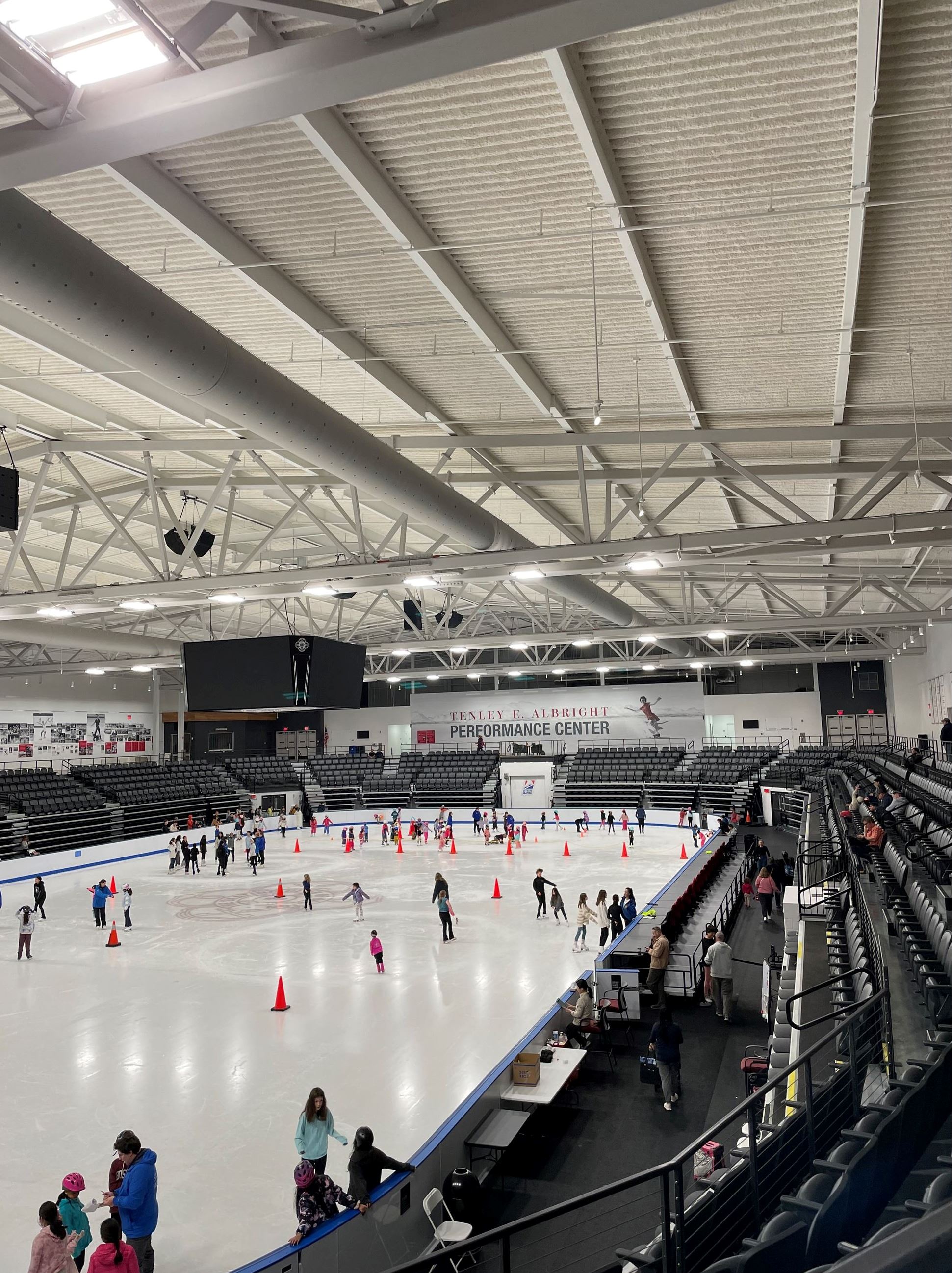 Photo of all the children from afar skating on the ice 
