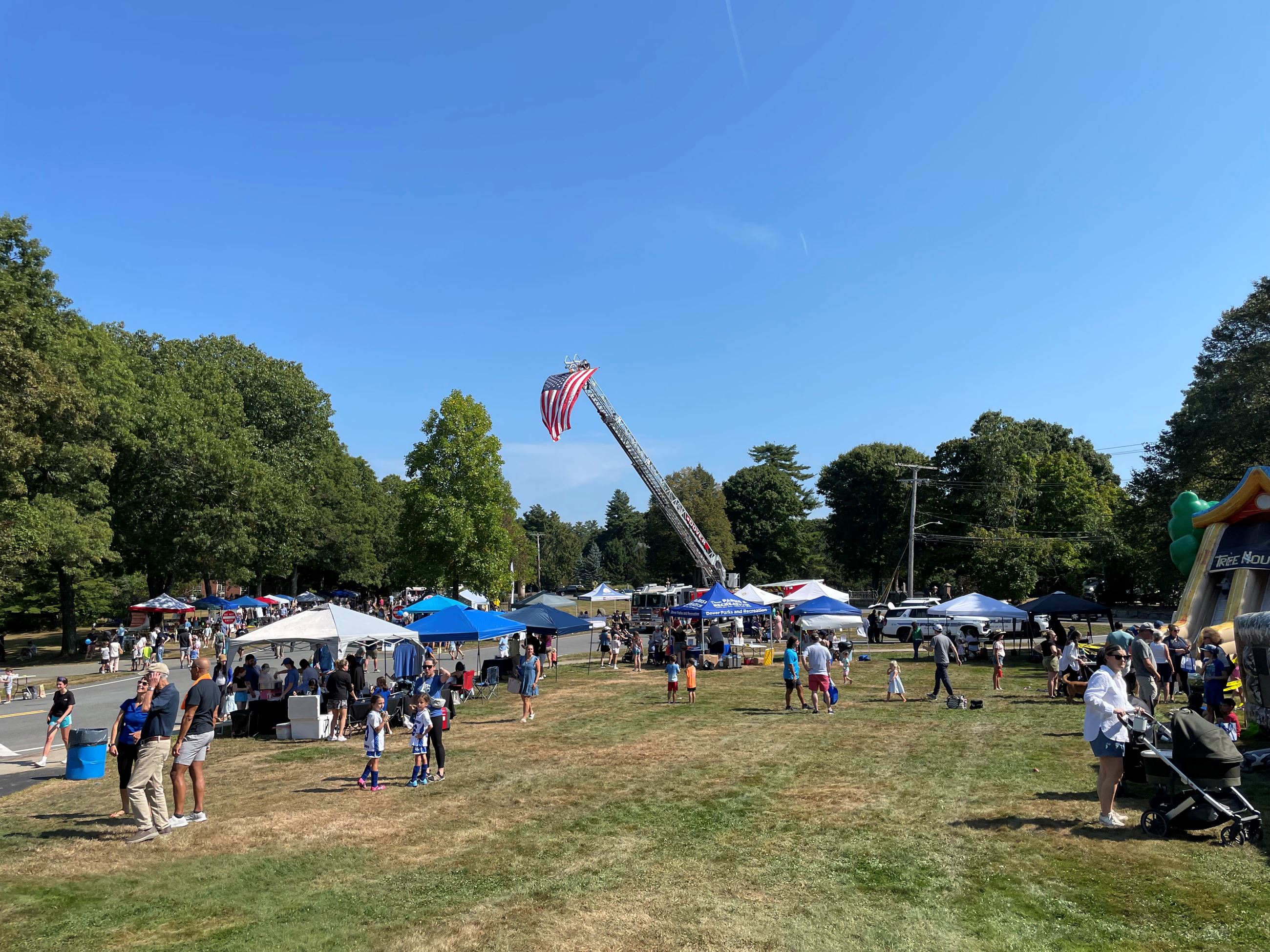 Photo from top of the hill looking over Dover Days with booths and flag in background